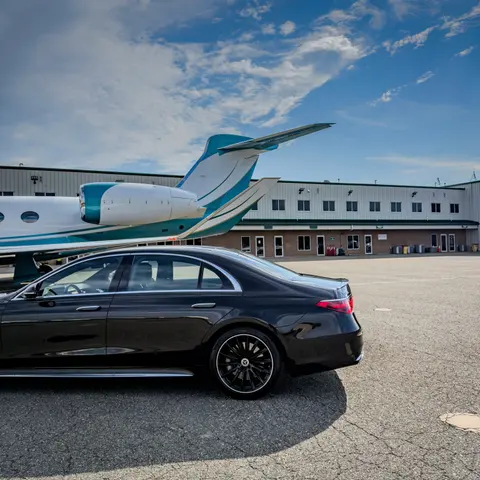 Mercedes-Benz S-Class staged plane-side at a private aviation FBO
