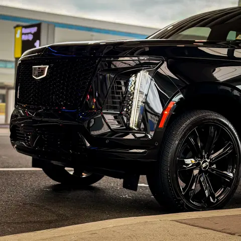 Cadillac Escalade ESV at the airport terminal curb